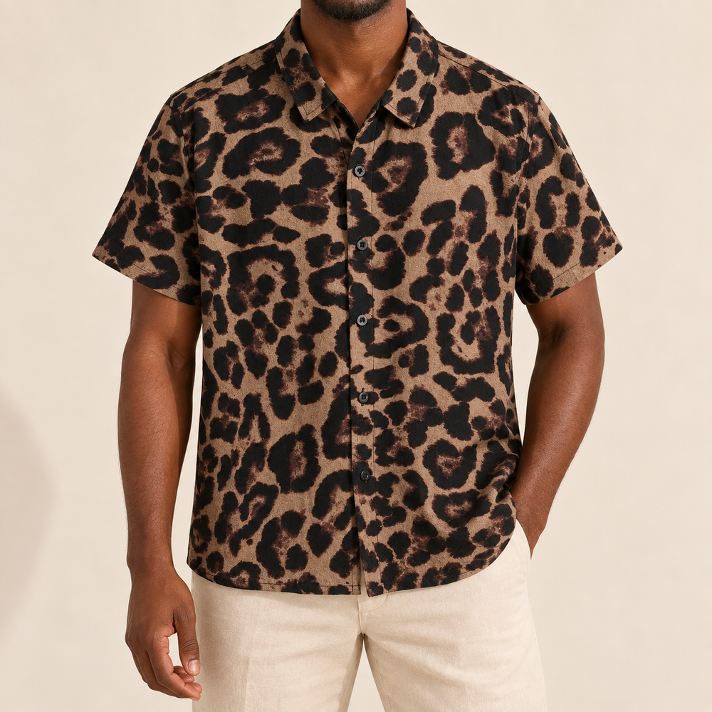 Model wearing brown short-sleeve button-up shirt with large dark animal spots
