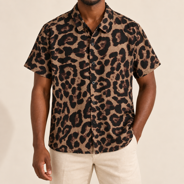 Model wearing brown short-sleeve button-up shirt with large dark animal spots