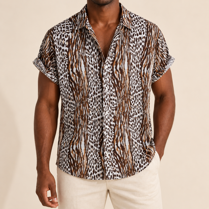 Model wearing brown, dark and pale short-sleeve shirt with narrow bands of animal markings