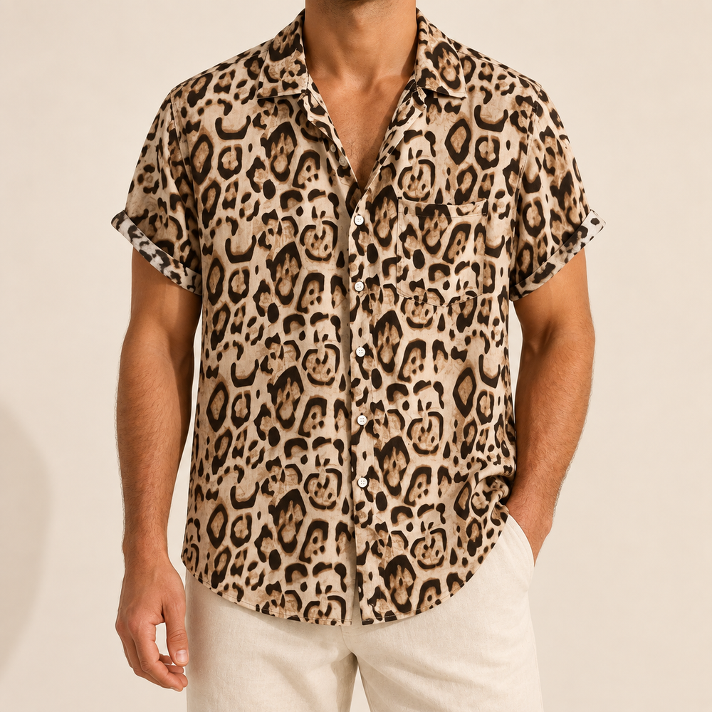 Model wearing a tan short-sleeve animal-print button-up shirt with a chest pocket