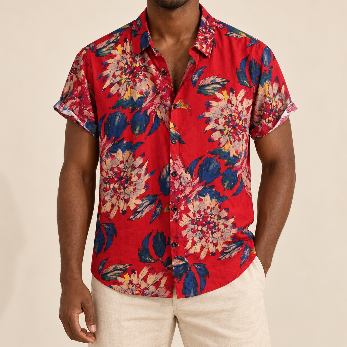 Model wearing crimson short-sleeve Hawaiian shirt with pale floral clusters and dark leaves
