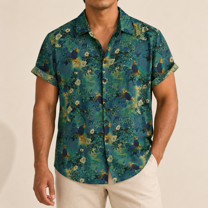 Model wearing dark green short-sleeve shirt with small muted flowers and leaf details