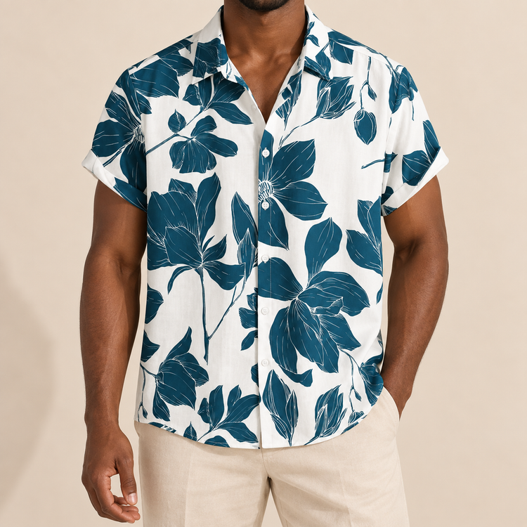 Model wearing a white short-sleeve shirt with oversized dark teal flowers