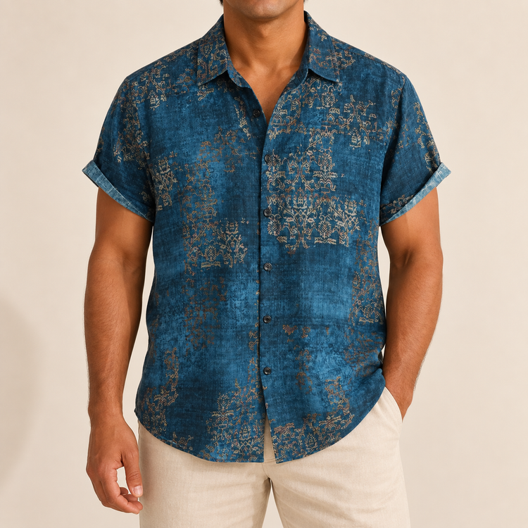 Model wearing a deep blue short-sleeve shirt with fine ornamental motifs