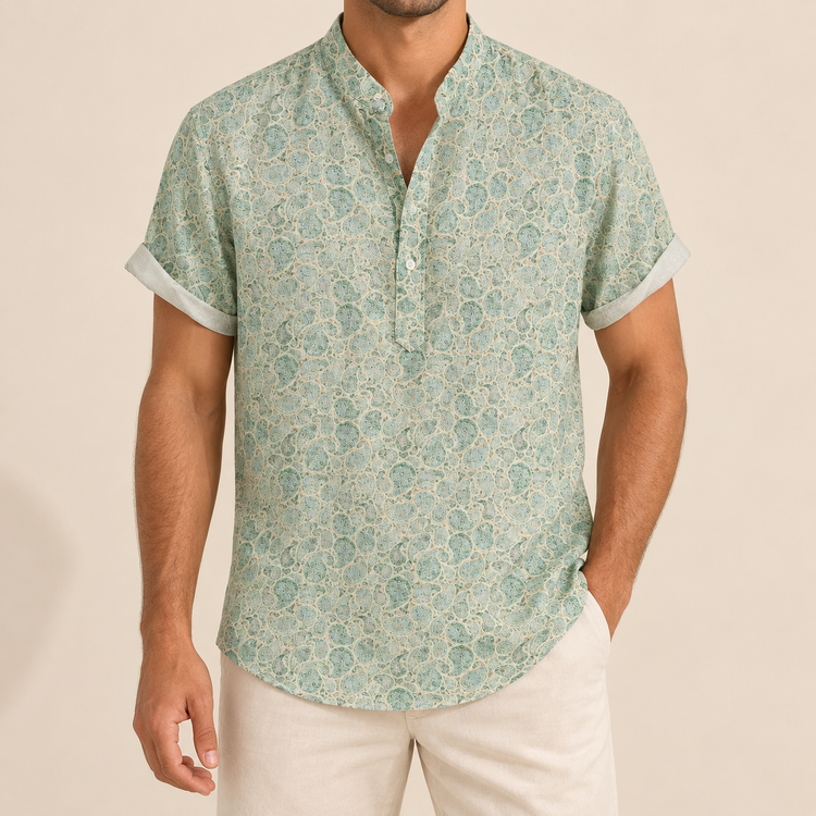 Model wearing a pale green short-sleeve band collar shirt with a fine repeating pattern