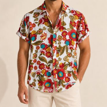 Model wearing a light short-sleeve shirt with multicolored flowers and curling stems