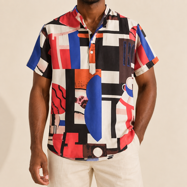 Model wearing a red, blue, black and cream geometric colorblock shirt