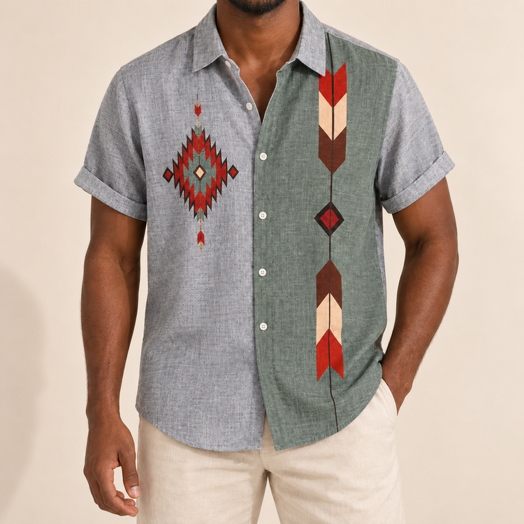 Model wearing gray and green short-sleeve shirt with diamond and arrow-like motifs