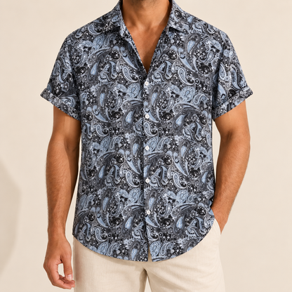 Model wearing a gray and black paisley short-sleeve button-up shirt
