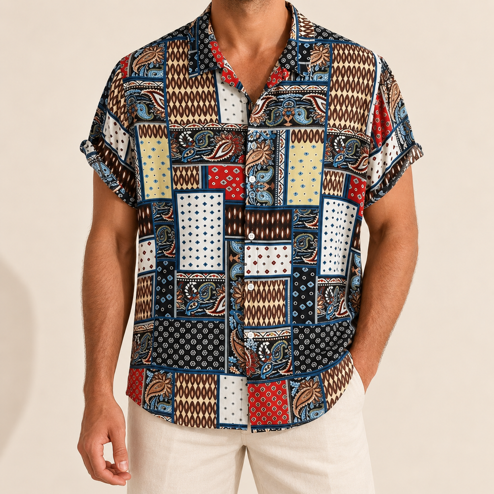 Model wearing a short-sleeve shirt with navy, cream and red patchwork patterns