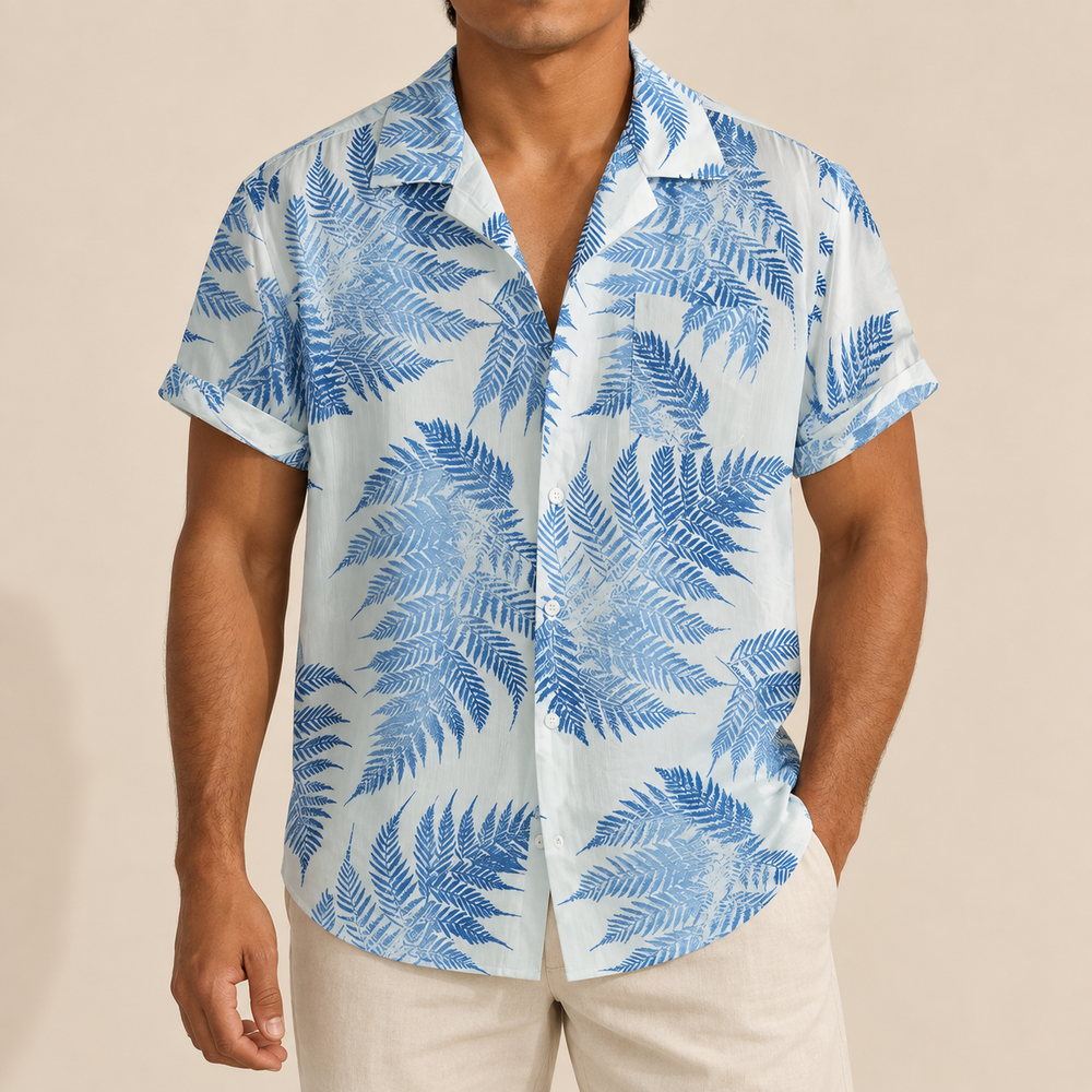 Model wearing a white short-sleeve shirt with blue fern leaves