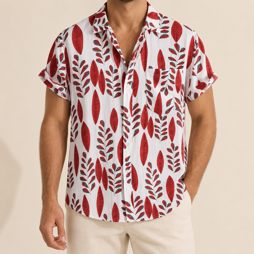 Model wearing a light Hawaiian shirt with repeating red leaf sprigs