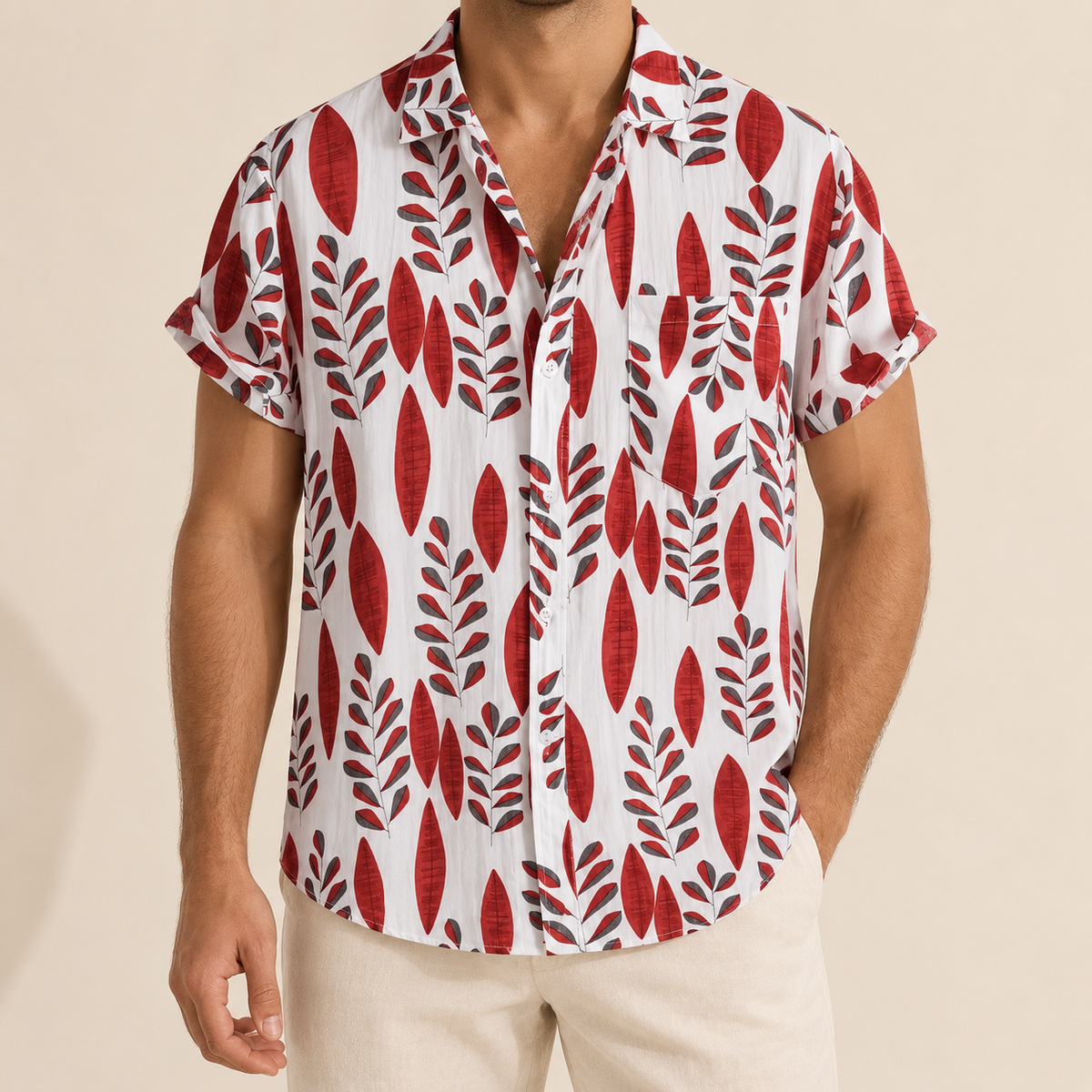 Model wearing a light Hawaiian shirt with repeating red leaf sprigs