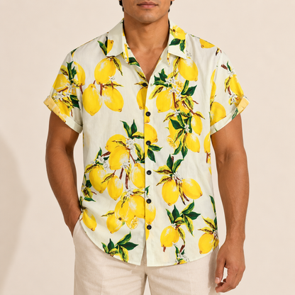 Model wearing a cream short-sleeve shirt with yellow lemons and green leaves