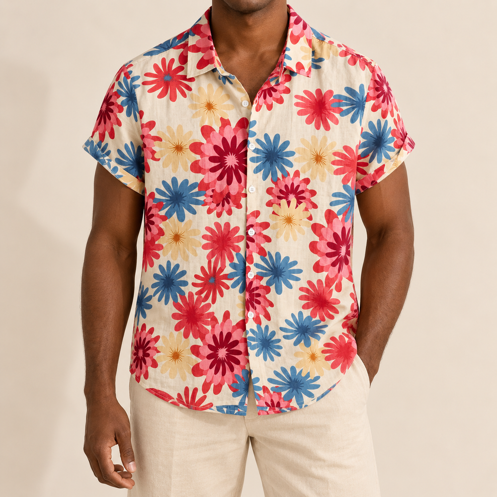 Model wearing light Hawaiian shirt with large pink, red and blue daisy-like flowers