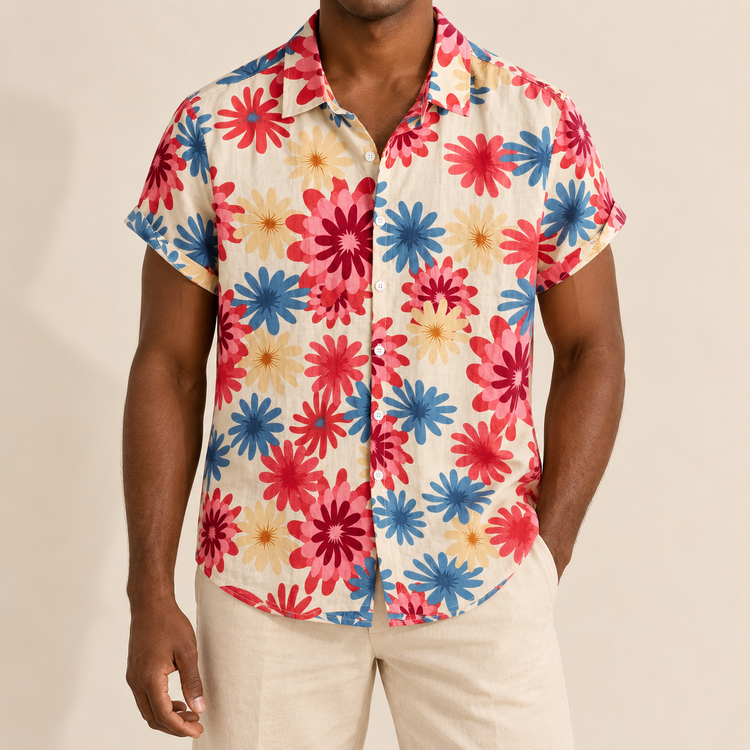 Model wearing light Hawaiian shirt with large pink, red and blue daisy-like flowers
