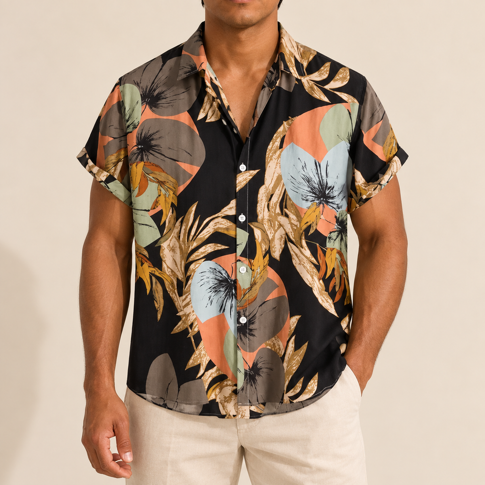 Model wearing a dark short-sleeve shirt with peach and sage botanical shapes
