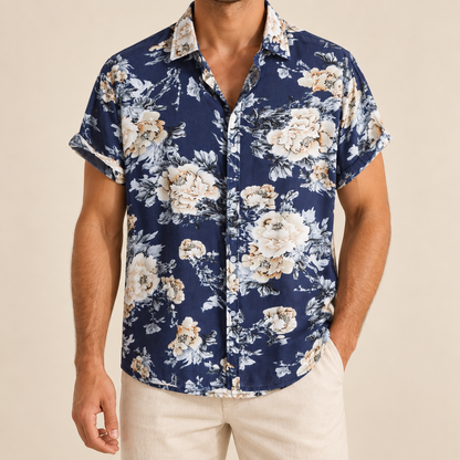 Model wearing a navy short-sleeve button-up shirt with pale floral clusters