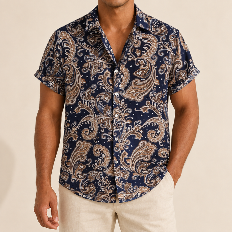 Model wearing a navy short-sleeve shirt with tan paisley motifs