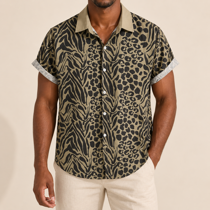 Model wearing olive-toned short-sleeve shirt with dark animal spots and stripes