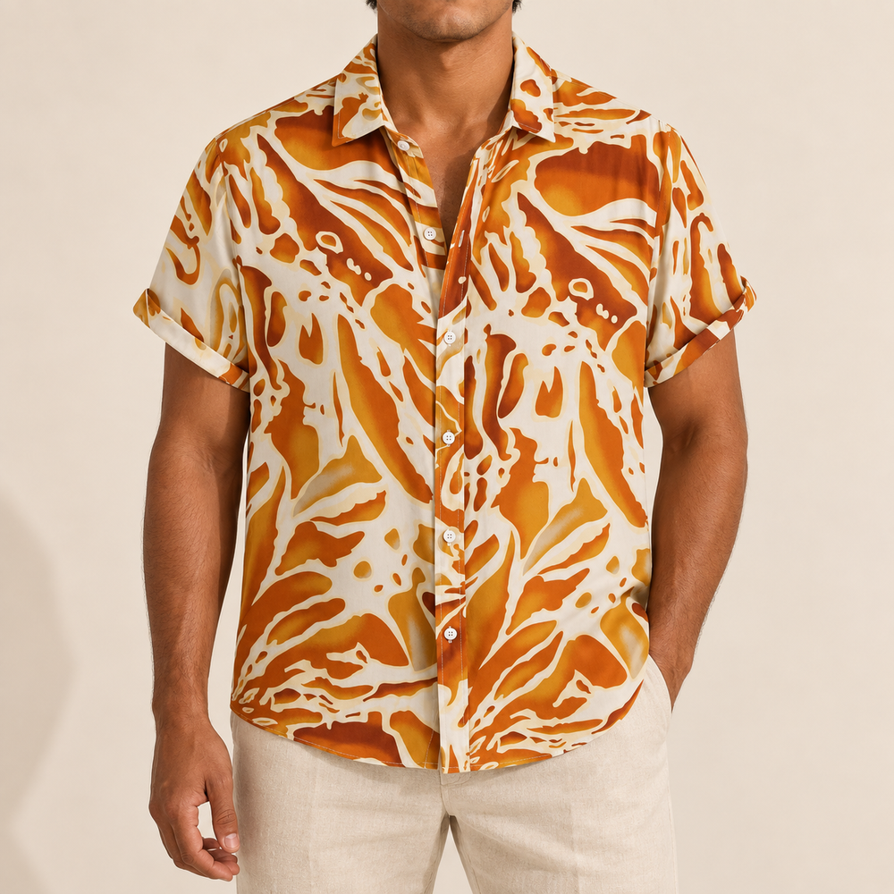 Model wearing a cream short-sleeve shirt with orange abstract waves