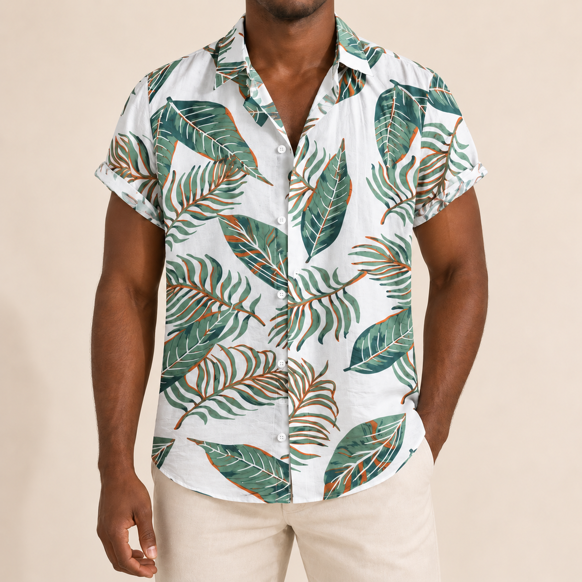 Model wearing a white short-sleeve shirt with green leaves and orange stems
