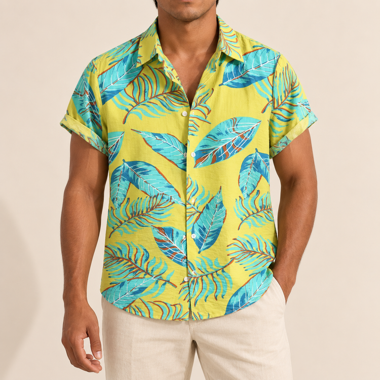 Model wearing a yellow short-sleeve shirt with turquoise outlined leaves