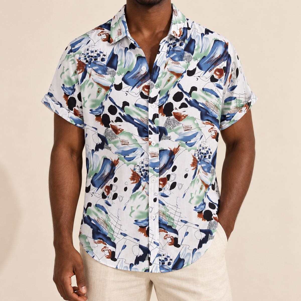 Model wearing a white short-sleeve shirt with blue and green painterly motifs