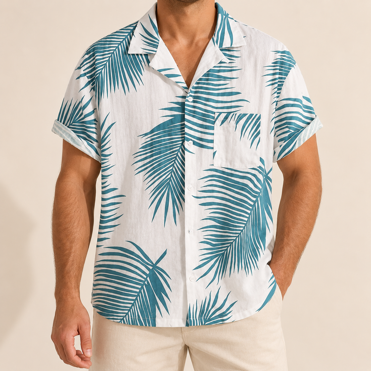 Model wearing a white short-sleeve button-up shirt with teal palm fronds