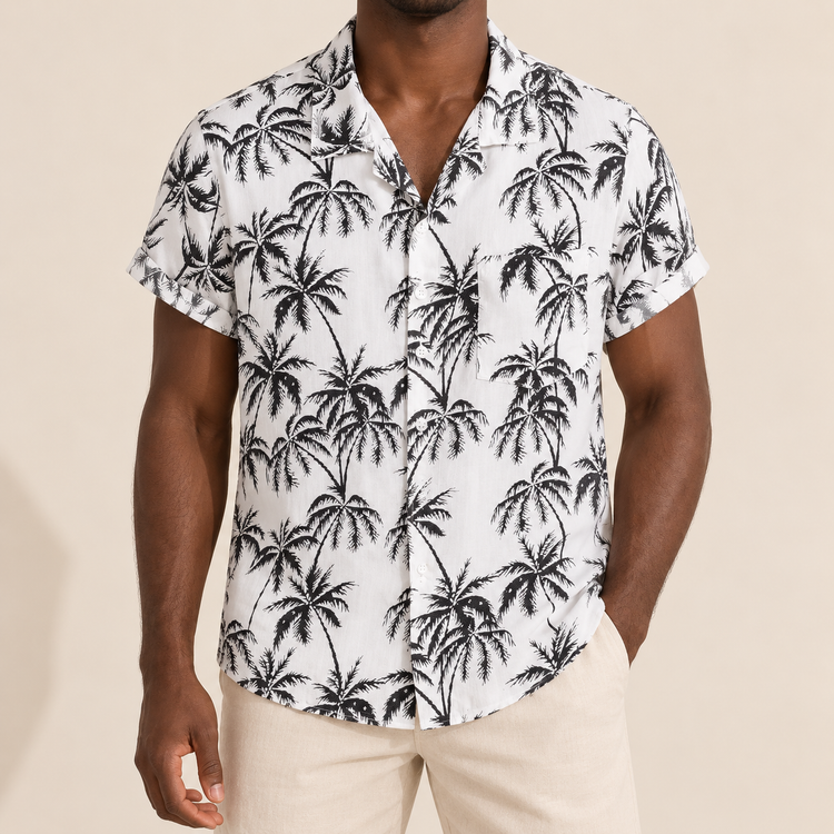 Model wearing a white short-sleeve shirt with black palm trees