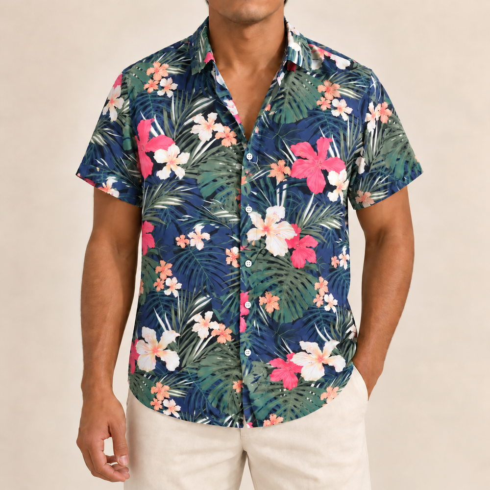 Model wearing a navy short-sleeve shirt with pink flowers and green palms