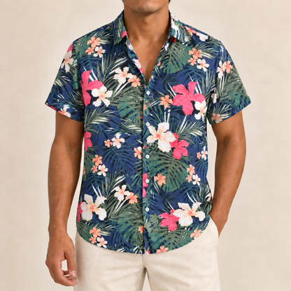 Model wearing a navy short-sleeve shirt with pink flowers and green palms