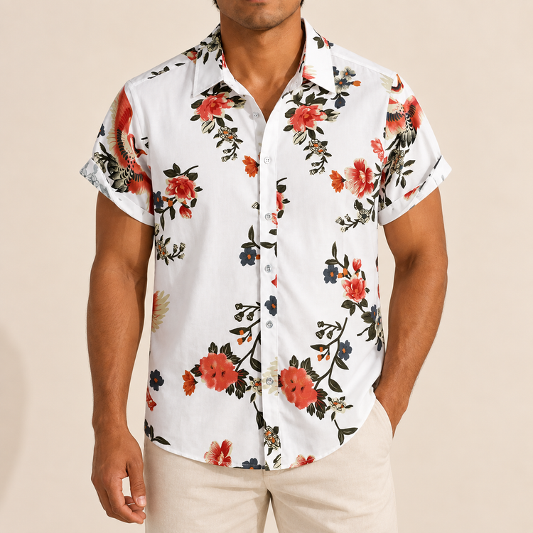 Model wearing a white short-sleeve shirt with coral blossoms and dark foliage