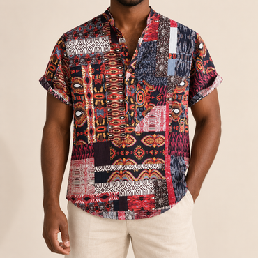 Model wearing a red and navy band-collar shirt with patterned borders