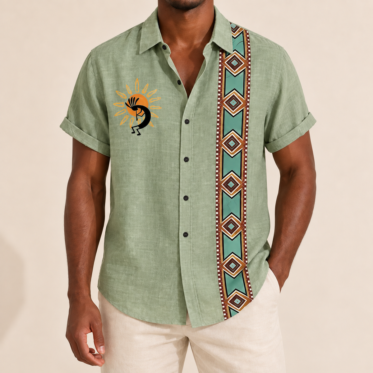 Model wearing sage green short-sleeve shirt with a vertical diamond border and small contrasting graphic
