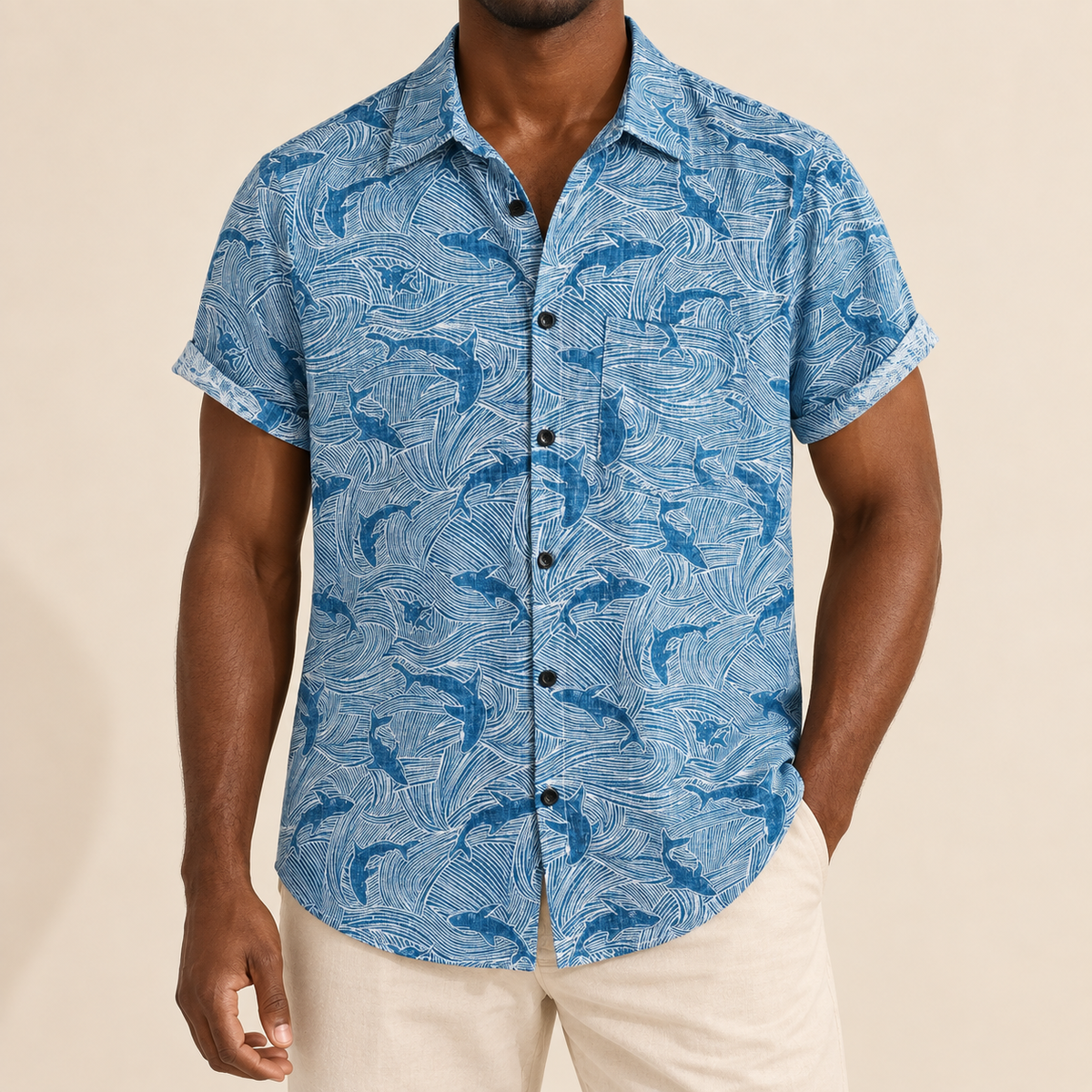 Model wearing a blue shark-print short-sleeve shirt with a chest pocket
