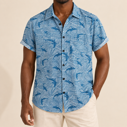 Model wearing a blue shark-print short-sleeve shirt with a chest pocket