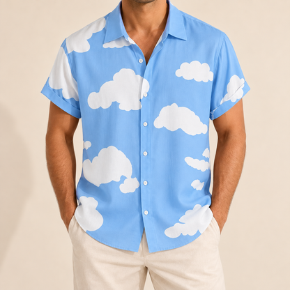 Model wearing a light blue short-sleeve button-up shirt with a white cloud print