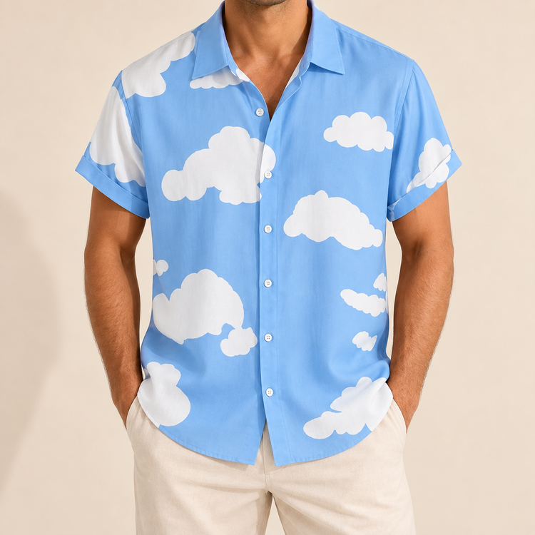 Model wearing a light blue short-sleeve button-up shirt with a white cloud print