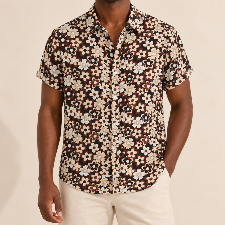 Model wearing a dark short-sleeve shirt with cream and brown flowers