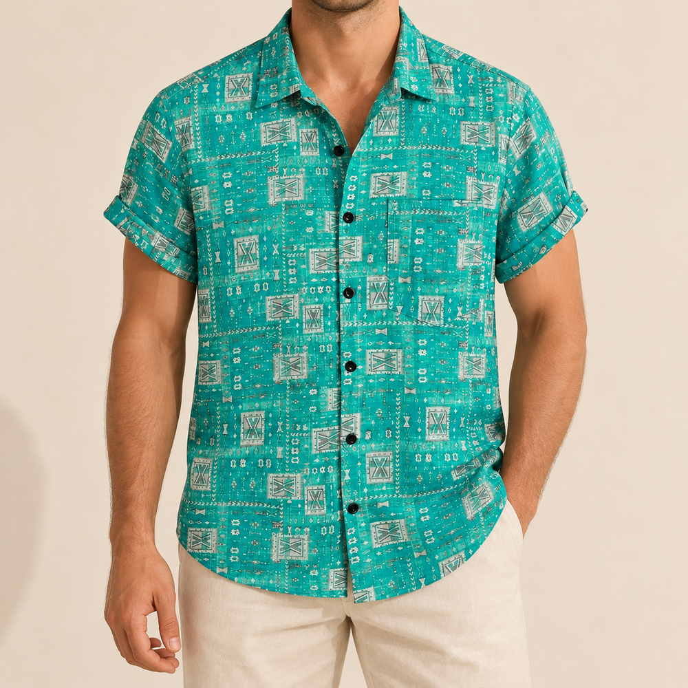 Model wearing a turquoise button-up shirt with small pale geometric tiles and a chest pocket