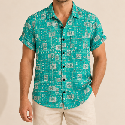 Model wearing a turquoise button-up shirt with small pale geometric tiles and a chest pocket
