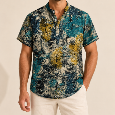 Model wearing a teal, gold and cream mottled-print short-sleeve band-collar shirt