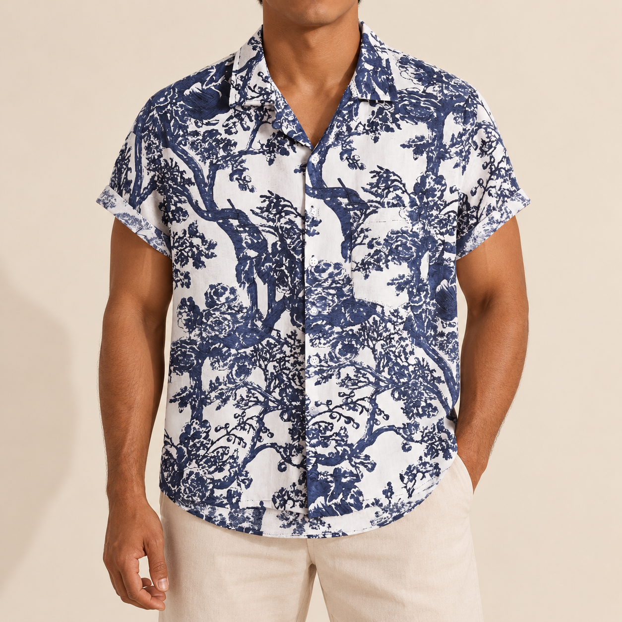 Model wearing a white short-sleeve shirt with a navy tree print