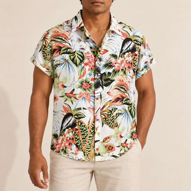 Model wearing a white short-sleeve shirt with green and coral tropical flowers