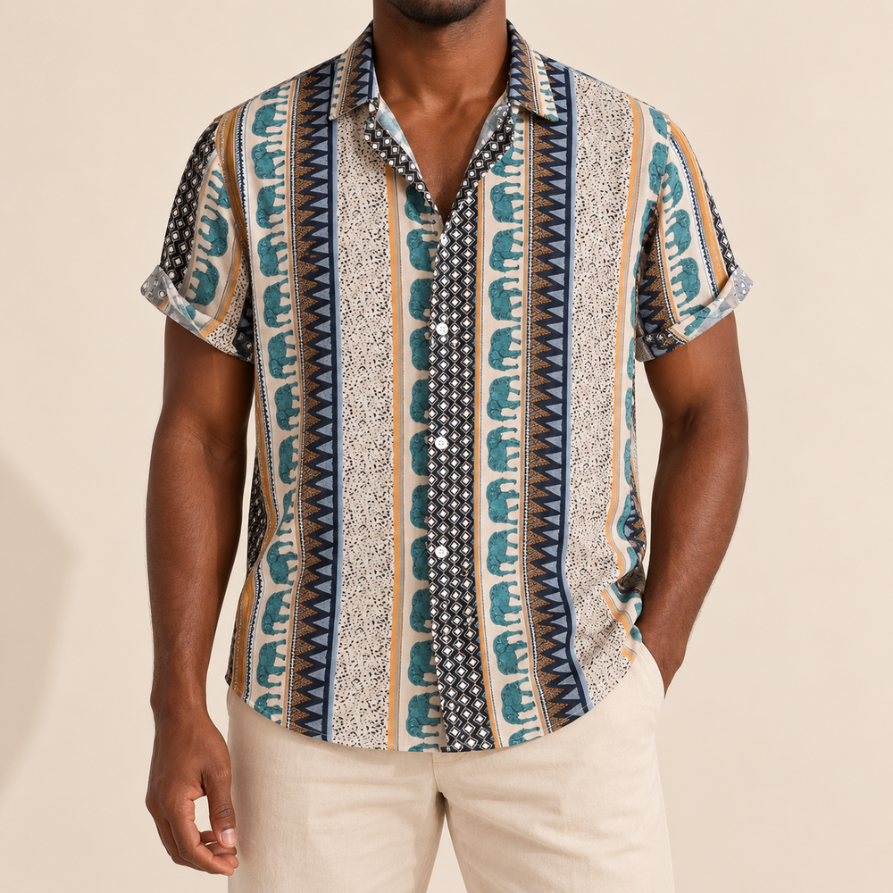 Model wearing a cream shirt with teal elephant stripes and geometric borders