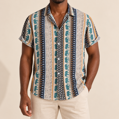 Model wearing a cream shirt with teal elephant stripes and geometric borders