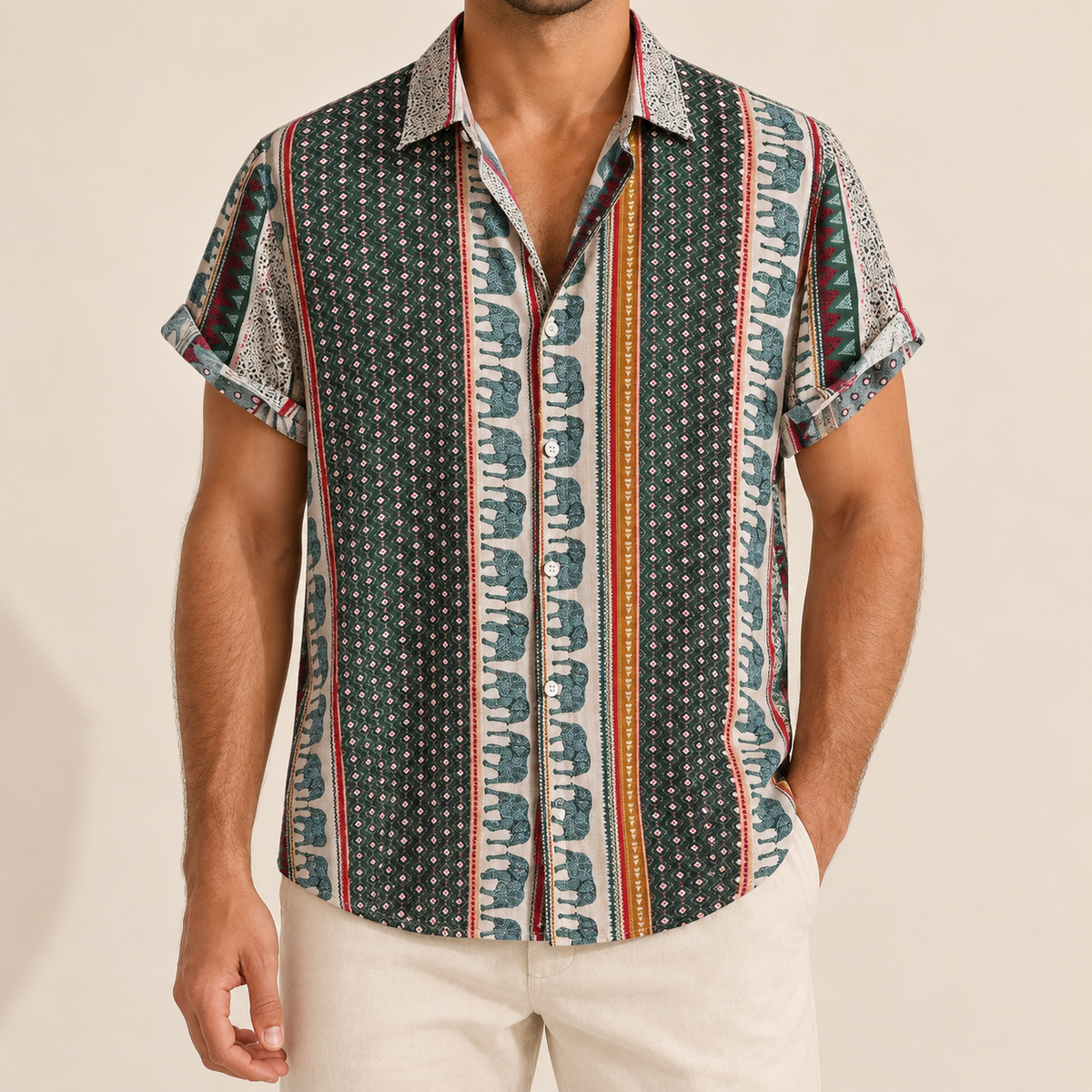Model wearing a short-sleeve shirt with green diamond panels and teal elephant-print borders